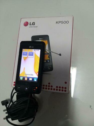 LG KP500 met oplader oordopjes en doos.