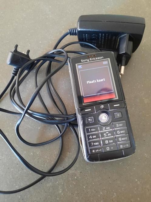 Sony Ericsson mobiel met oplader.